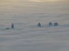 BuildingsAntennaeAboveClouds.jpg