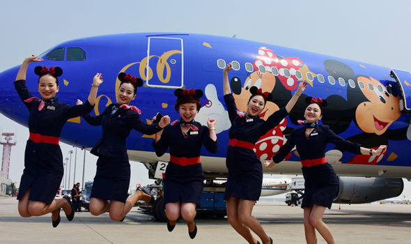 Happy-flight-attendants-jump-by-Disney-plane-567504.jpg