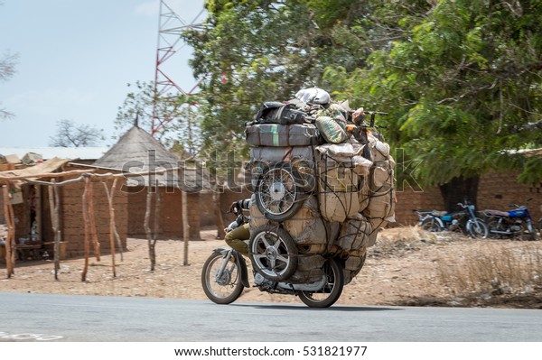 motorcycle-carrying-stuff-overloaded-cameroon-600w-531821977.jpg