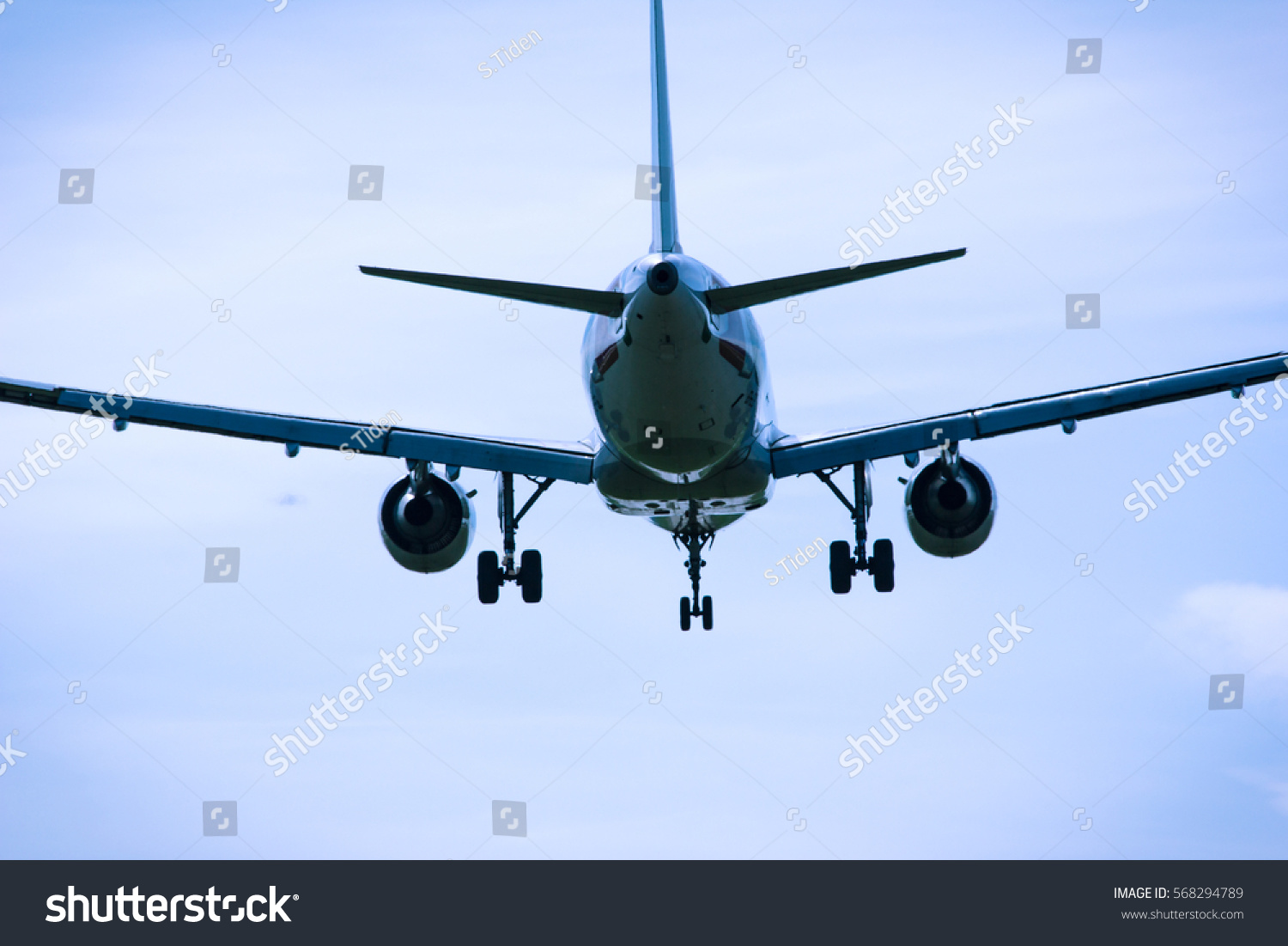 stock-photo-flying-jet-aircraft-in-the-sky-rear-view-close-up-568294789.jpg